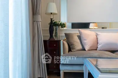 Elegant living room with plush sofa, stylish lamp, and chic decor