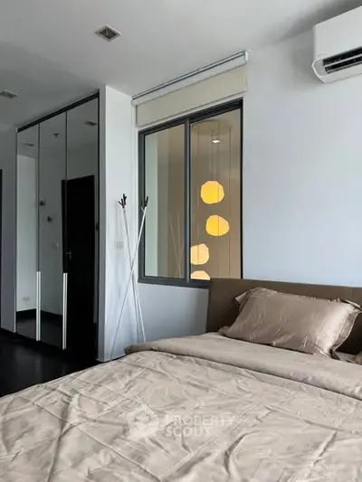 Modern bedroom with mirrored wardrobe and neutral tones