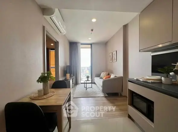 Modern apartment interior with cozy living room and dining area, featuring stylish decor and natural light.