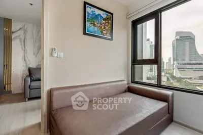 Modern apartment with city view featuring a cozy seating area and stylish decor.