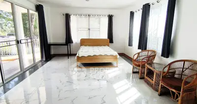 Spacious bedroom with large windows and elegant marble flooring