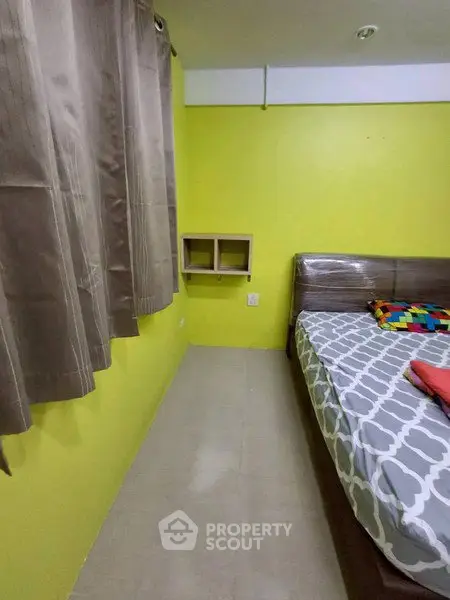 Cozy bedroom with vibrant yellow walls and modern furnishings