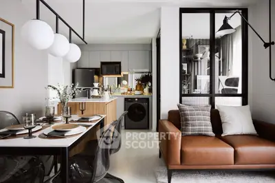 Modern open-plan living room and kitchen with stylish decor and cozy seating area.