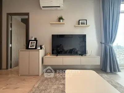 Modern living room with sleek TV setup and city view window, perfect for urban living.