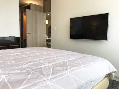 Modern bedroom with wall-mounted TV and stylish decor