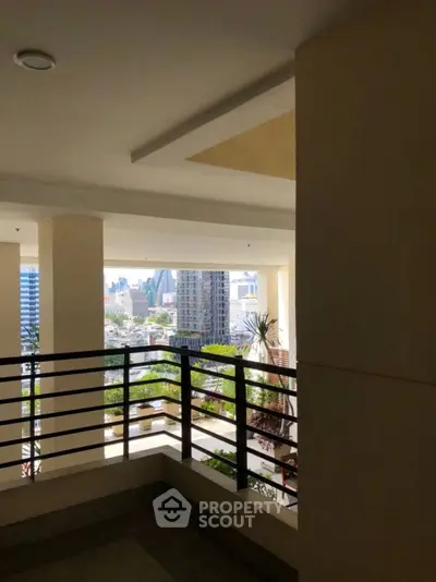 Spacious balcony with city skyline view, perfect for urban living enthusiasts.