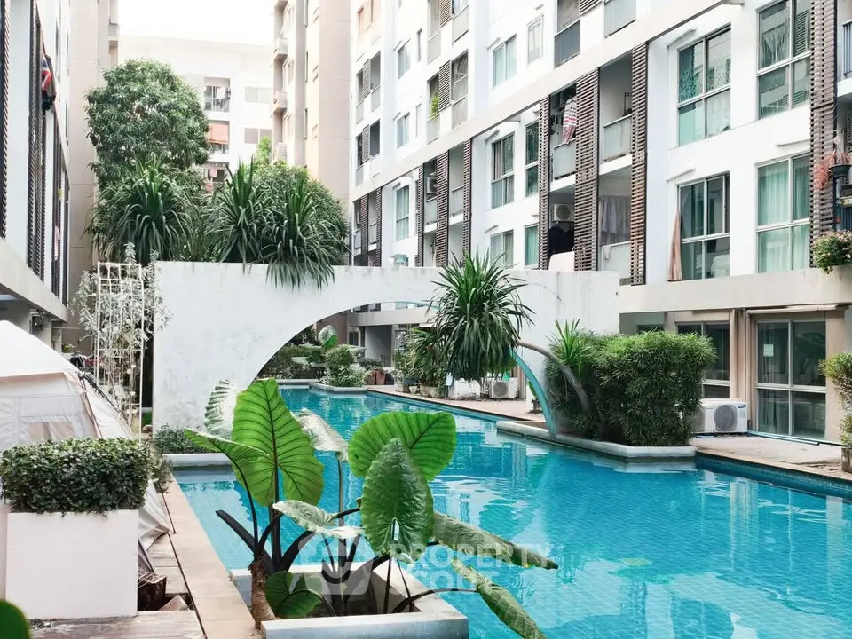 Luxurious apartment complex with stunning pool and lush greenery, perfect for relaxation and leisure.