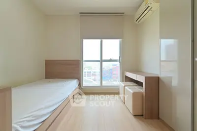 Modern minimalist bedroom with single bed and city view window