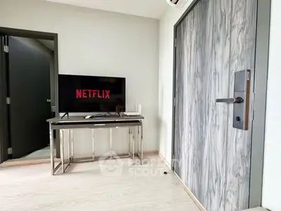 Modern living room with TV and stylish door, perfect for cozy entertainment nights.