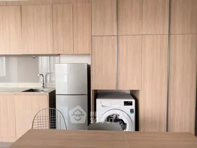 Modern kitchen with integrated appliances and sleek wooden cabinetry