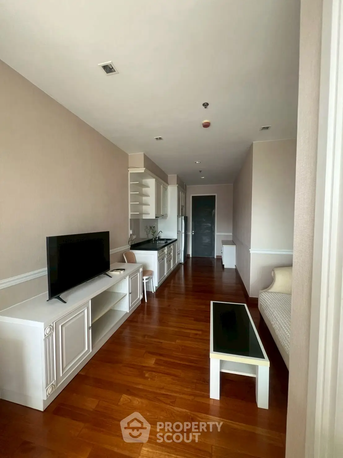 Chic and cozy living room with elegant wooden flooring and modern furnishings.