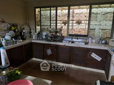 Spacious kitchen with ample storage and natural light, featuring modern appliances and a cozy atmosphere.
