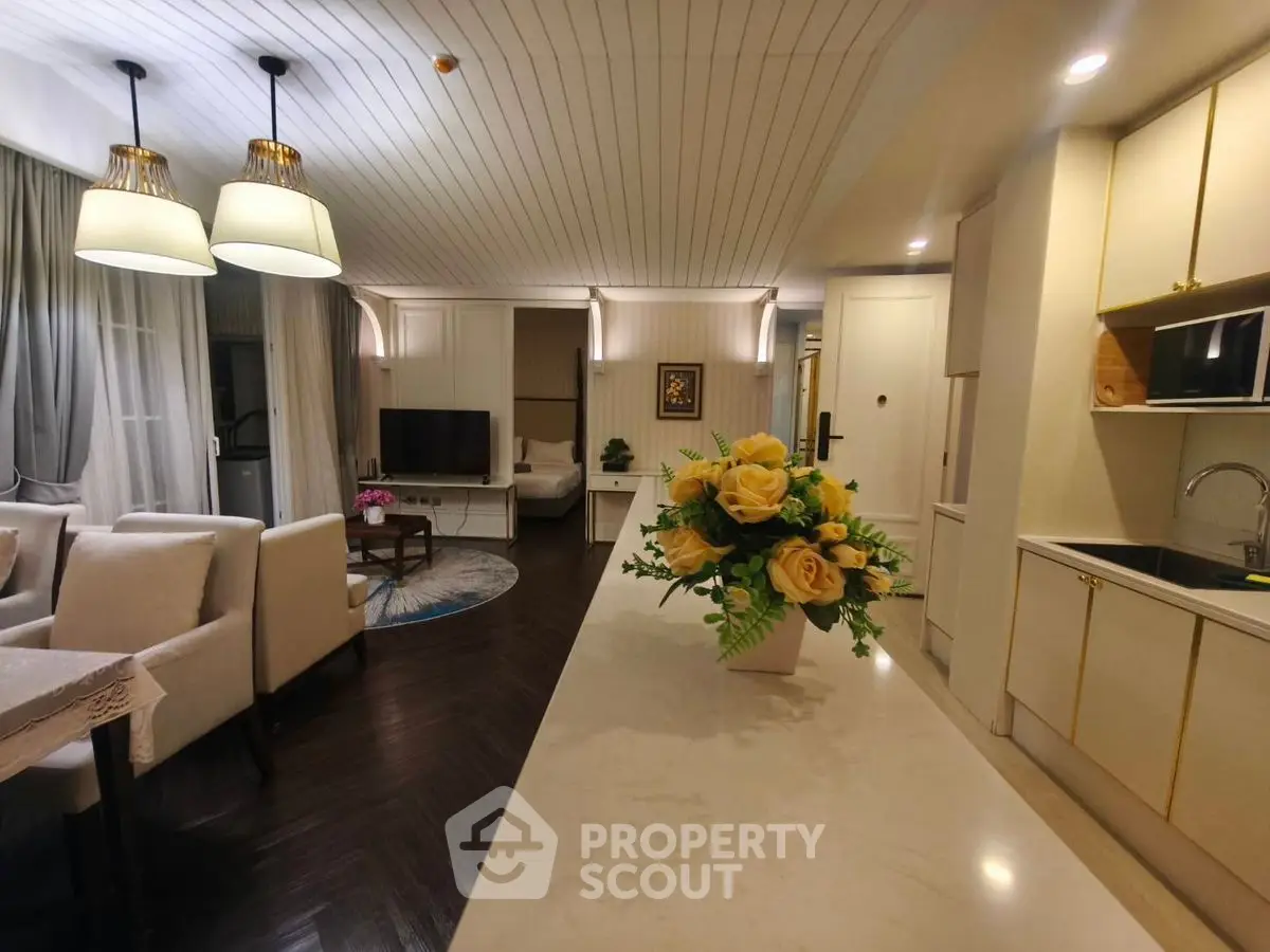 Elegant open-layout living room and kitchen with modern decor and cozy ambiance.
