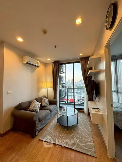 Modern living room with city view, featuring cozy sofa and stylish decor.