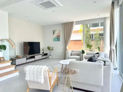 Spacious modern living room with large windows and stylish furniture