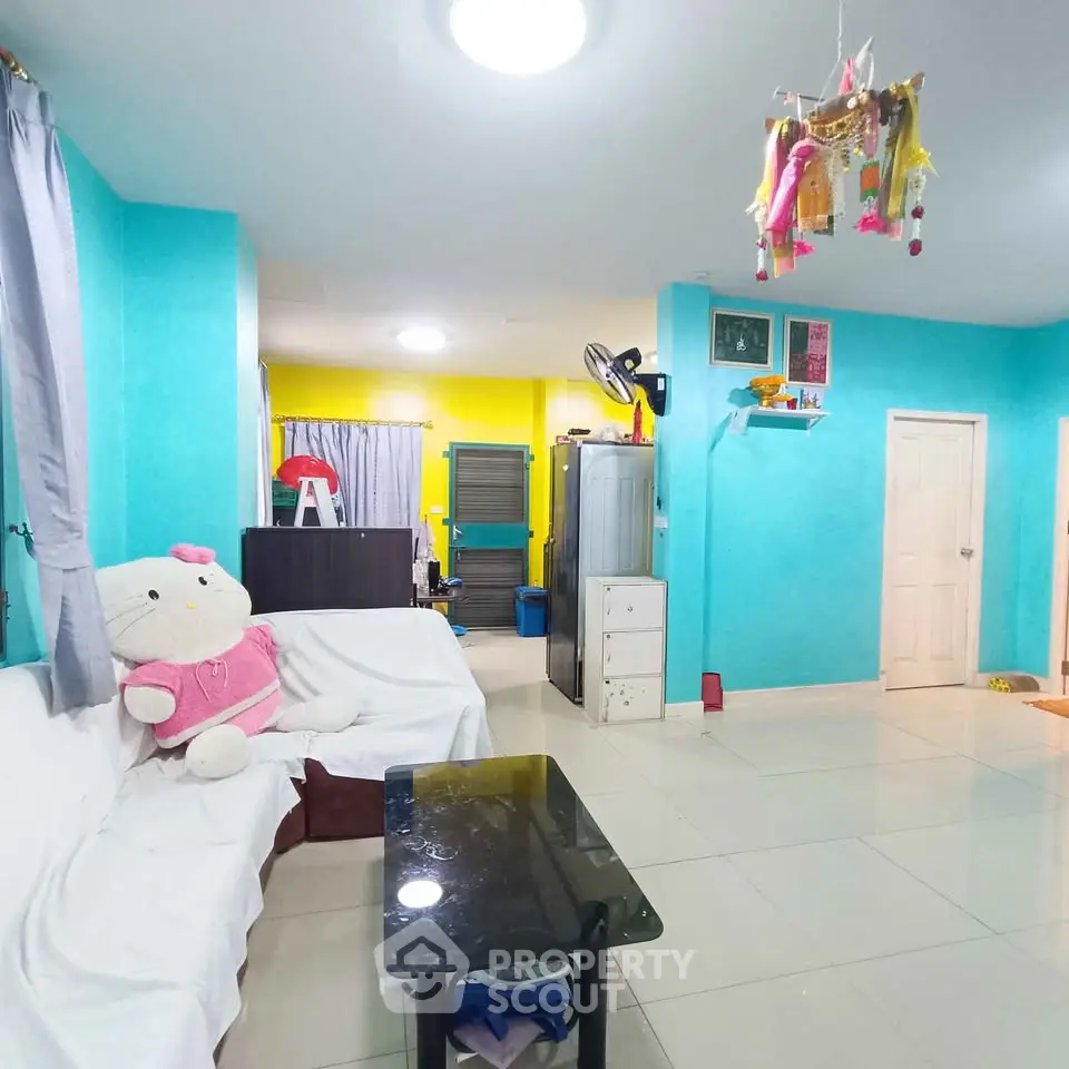 Vibrant living room with colorful walls and cozy furniture, perfect for family gatherings.