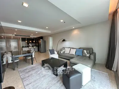 Spacious modern living room with open kitchen and stylish furniture in luxury apartment.