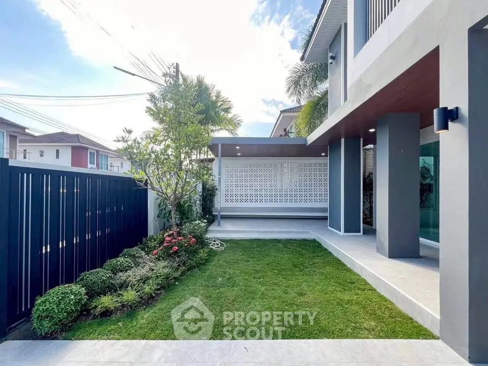 Modern house exterior with lush garden and sleek design