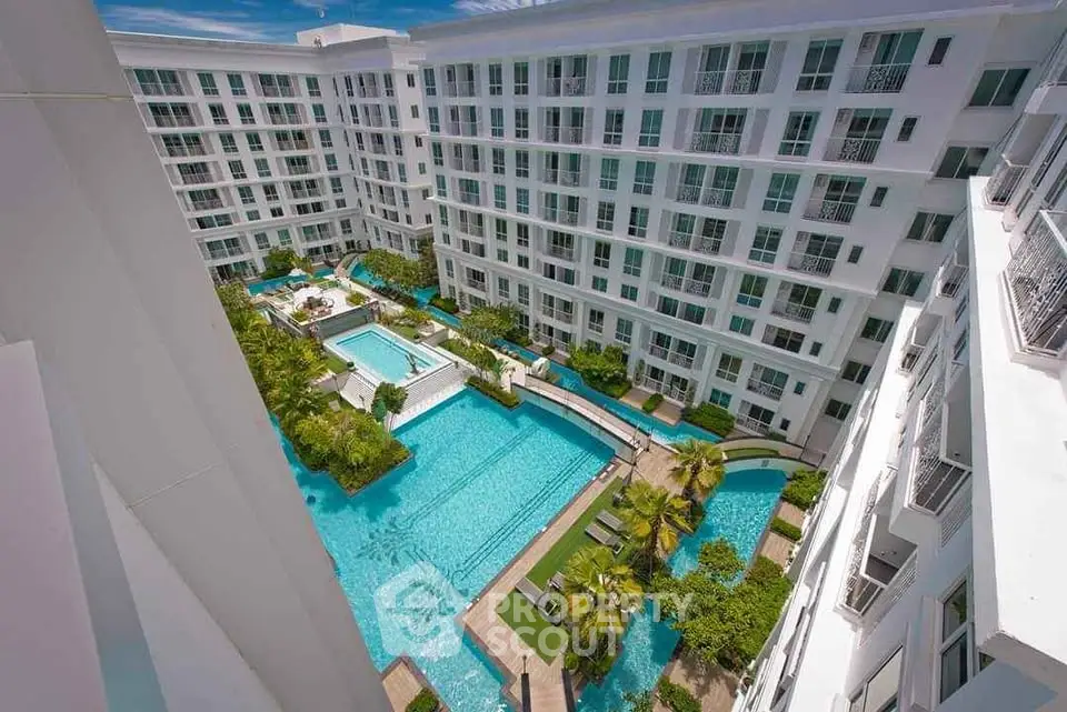 Luxurious condominium with stunning pool and lush garden view