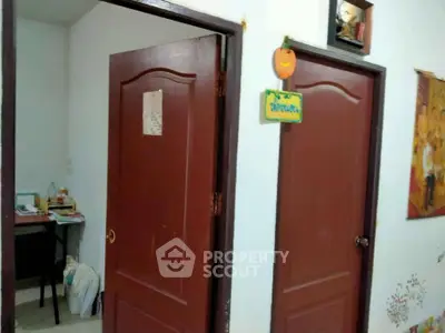 Cozy interior hallway with wooden doors and a small study nook