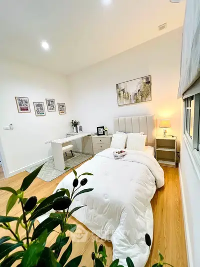 Chic and cozy bedroom with modern decor and natural light, perfect for relaxation and comfort.