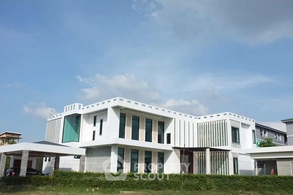 Modern architectural masterpiece with sleek design and expansive windows in a serene neighborhood.
