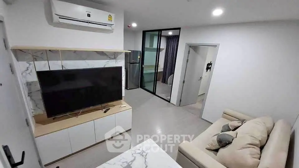 Modern living room with sleek TV unit and comfortable sofa in stylish apartment