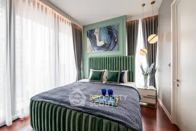 Luxurious bedroom with elegant decor and large windows offering natural light