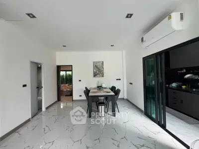 Modern dining area with sleek marble flooring and open kitchen layout