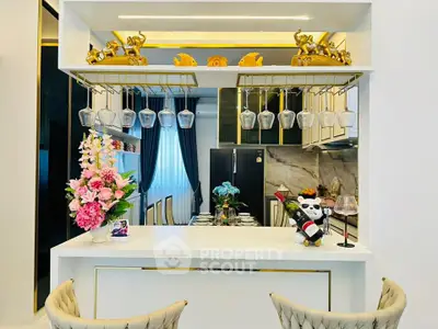 Luxurious modern kitchen with elegant decor and open layout, featuring stylish bar counter and plush seating.