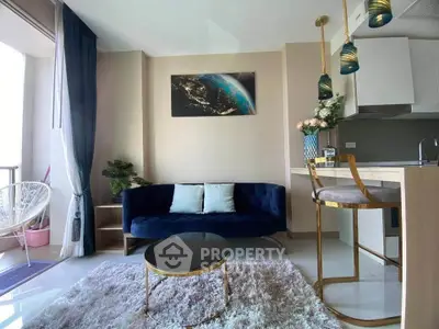 Stylish modern living room with plush sofa, chic decor, and open kitchen layout in a bright apartment.