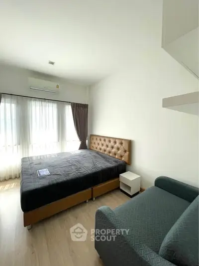 Bright and cozy bedroom with modern furnishings and ample natural light.