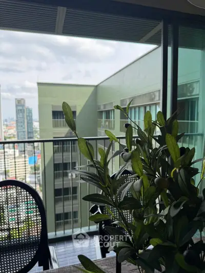 Stunning city view from a modern balcony with lush greenery and stylish seating.