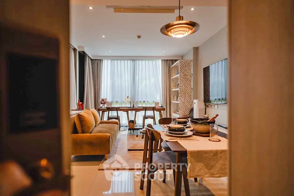Stylish modern living room with cozy seating and elegant dining area, perfect for urban living.