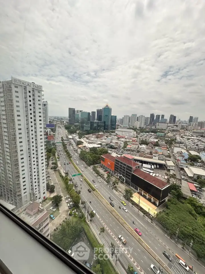Stunning cityscape view from high-rise building window, showcasing urban skyline and bustling streets.
