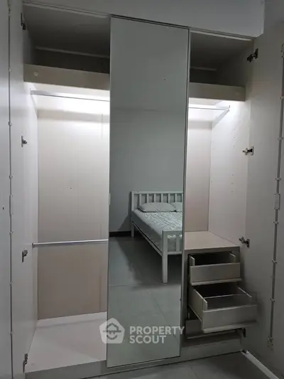 Spacious bedroom with mirrored wardrobe and bed, perfect for modern living.