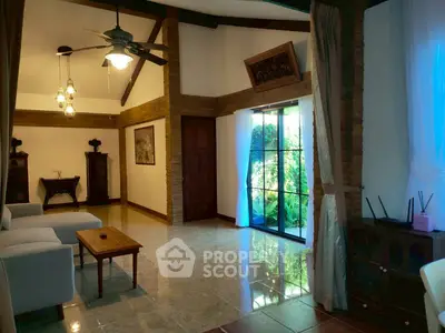 Charming living room with high ceilings and garden view