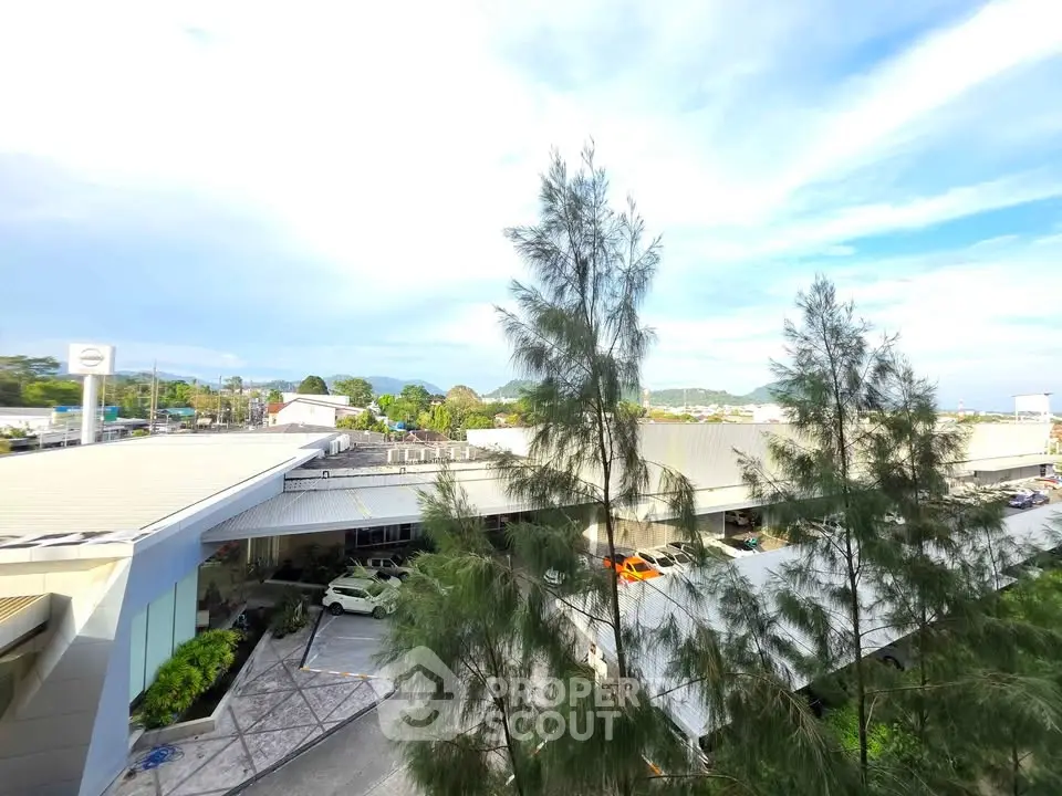 Expansive view of commercial building with lush greenery and clear blue sky