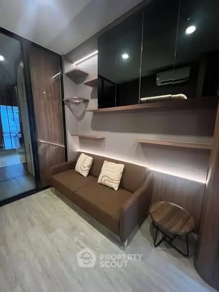 Modern living room with stylish brown sofa and wooden shelves, perfect for cozy relaxation.