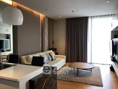 Modern living room with stylish decor and natural light, featuring a cozy sofa and sleek coffee table.
