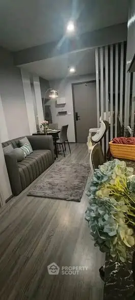 Modern living room with sleek design and cozy atmosphere, featuring stylish furniture and elegant decor.