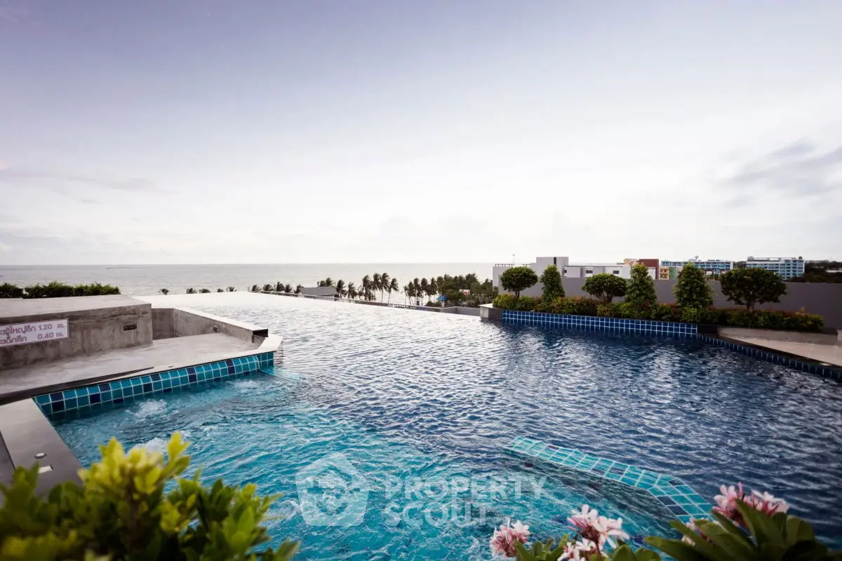 Stunning rooftop infinity pool with ocean view and lush greenery