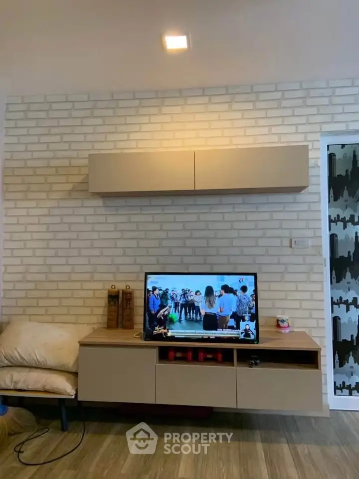 Modern living room with stylish TV unit and brick accent wall