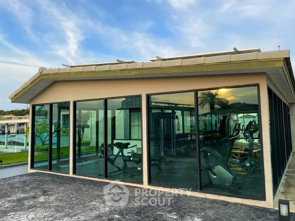 Modern gym with glass walls offering scenic views in luxury property