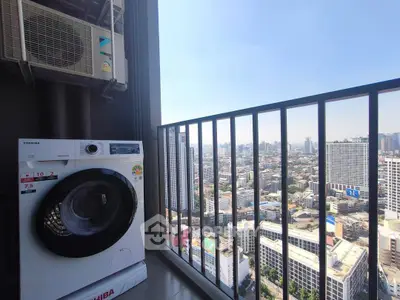 High-rise balcony with city view and washing machine, perfect for urban living.