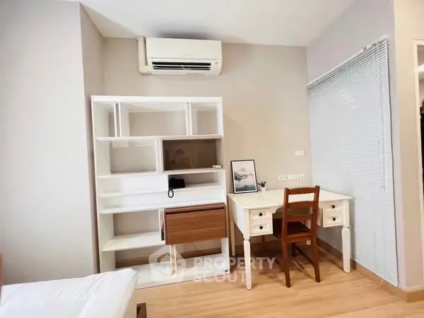 Modern study room with sleek desk, chair, and stylish shelving unit, perfect for productivity.