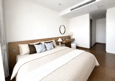 Spacious modern bedroom with elegant decor and wooden flooring