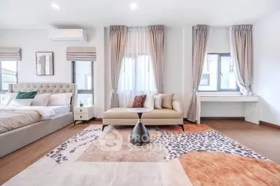 Spacious modern bedroom with elegant decor and natural light