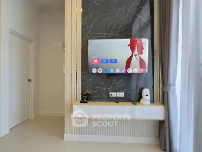Modern living room with wall-mounted TV and stylish decor