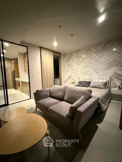 Modern studio apartment with cozy bed and stylish living area